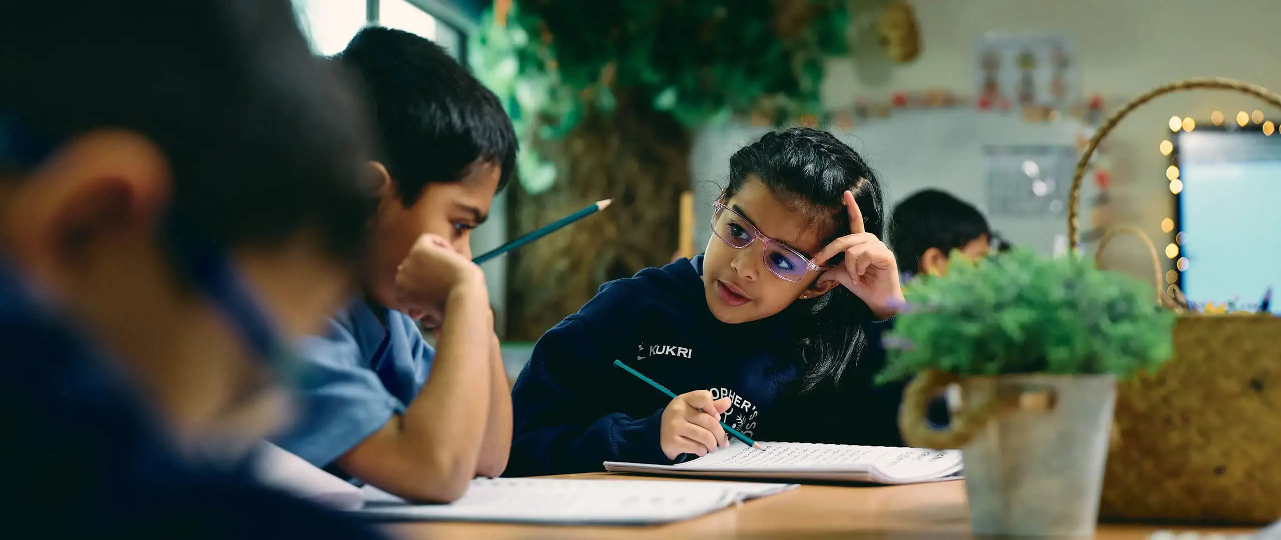 Students at St Christopher's Intentional Private British Curriculum School actively participating in a classroom lesson, showcasing the dynamic and interactive learning environment of the British Curriculum. The image captures diverse students collaborating, engaged in discussions, and working on educational activities that foster critical thinking and creativity.
